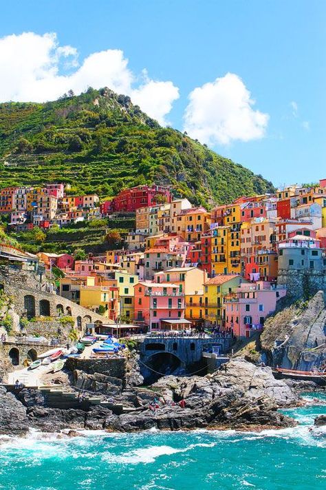 Manarola, Italy - It's in the province of La Spezia, Liguria, northern Italy. A unique place called 'Cinque Terre ' (which means Five Towns literally and this is one of the town, they are right next to each other). If you go to Tuscany, you can make a day trip there. Riomaggiore Italy, Colorful Buildings, Colorful Houses, Cinque Terre Italy, Grand Cayman, Vatican City, Machu Picchu, Pretty Places, Places Around The World