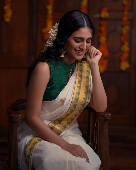 Priya Prakash Varrier in a kasavu saree with green border and matching shirt blouse, pearl studded jhumkas by Ajio Life! Onam Photoshoot, Priya Varrier, Priya Prakash Varrier, Saree Shoot, Saree Pose, Priya Prakash, Marathi Culture, Fancy Clothing, Onam Outfits