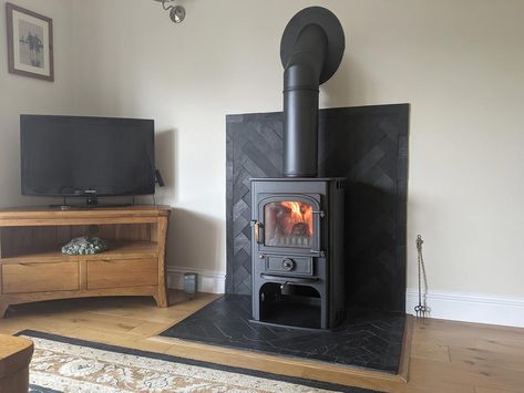 Slate Tile Wood Stove Surround, Tiling Behind Log Burner, Wood Stove Surround Corner, Stove Corner Ideas, Wood Stove Heat Shield, Earthy House, Herringbone Fireplace, Wood Stove Surround, Woodburning Stove Fireplace