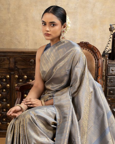 Featuring an exquisite Kanchipuram silk saree in a handcrafted grey brocade floral design with pure zari, showcasing a unique color palette enhanced by a luxurious gold zari sheen. The saree is meticulously woven with a self zari border and a beautifully opulent rich pallu. Saree code: CL35168 Unique Color Palette, Kanchipuram Silk Saree, Saree Look, Unique Colors, Silk Saree, Silk Sarees, Color Palette, Floral Design, Saree