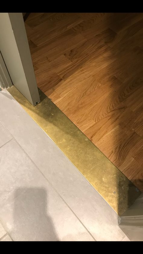 Brass Threshold Brass Strip Floor, Metal Flooring Transition, Wood Threshold Ideas, Brass Threshold Strip, Flooring Threshold Transition, Brass Threshold Transition, Transitions Between Tile And Wood Floors, Creative Floor Transitions, Brass Floor Transition Strip