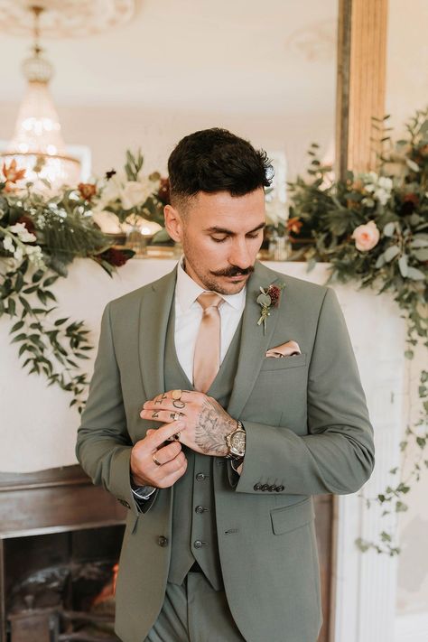 Groom in three piece green wedding suit and pink tie with matching pink pocket square Men Wedding Groom Outfit, Suit Colors For Men Wedding Spring, Mens Winter Wedding Outfit, Khaki Suit With Sage Green, Sage Green Wedding Men, Green Groom Suit With Groomsmen, Men’s Spring Wedding Suit, Sage Green And Pink Groomsmen, Eucalyptus Suit Wedding