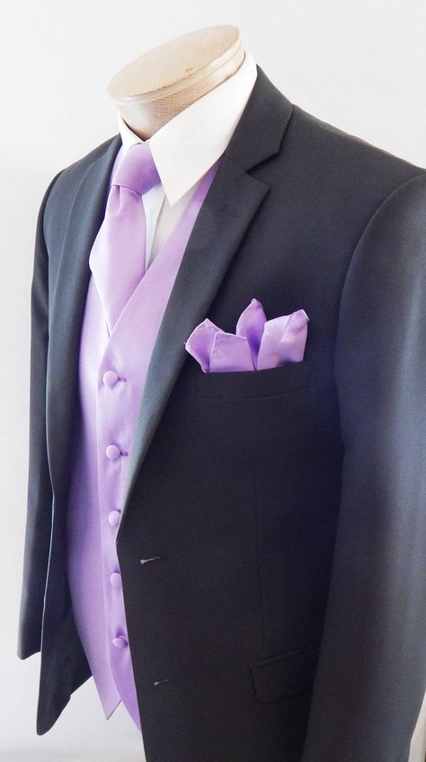 Silk Feel Microfiber Satin Full Back And Adjustable Vest set. The Vest Is Fully Lined With Matching Material Covered Buttons. It Comes With Two Outside Lined Pockets A Regular Four In Hand Tie Measurements Are 58 Inches Long And 3 1/4 Inch Wide With The Matching Fabric Pocket Square. Purple Suits For Men Quince, Light Purple Tuxedo For Men, Black Suit With Lilac Tie, Black And Lavender Tuxedo, Lilac Quinceanera Chambelanes, Lavender Suit Men Wedding, Black Suit Lilac Tie, Chambalans Outfits Quince Purple, Light Purple Suits For Men