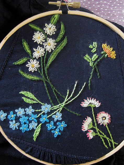 flower embroidery.  Normally flowers are embroidered on a light colored fabric, but the navy blue looks very nice. Cassie Stephens, Hand Embroidery Tutorial, Pola Sulam, Red Squirrel, 자수 디자인, Embroidery Needles, Satin Stitch, Flower Embroidery, Embroidery Inspiration