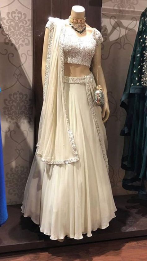 Beautiful cream-white Georgette-Silk Lehenga with Hand Embroidered blouse.  Embellished with dupatta.  The color of this Lehenga is so classic and sober. Milk silver hand embroidery give much glitter and shine. #Lehenga #traditional #festival #handembroidery #asmaira #design Cream Colour Lehenga, Off White Lehenga Combination, Georgette Lehenga Designs, White Georgette Lehenga, Cream Lehenga, Lehenga Traditional, Lehenga White, White Lehenga Choli, Glitter Gown