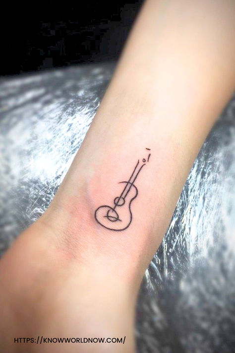 Small Guitar Tattoo On Wrist
#GuitarTattoo #WristTattoo #TinyTattoo #MusicInk #WristInk #BodyArt #TattooLove #MiniatureTattoo #GuitarInk #ArtisticTattoo #SmallInstrumentTattoo #WristInkArt #MusicLoversTattoo #InkedGuitar #TinyArt #TattooedMelody #GuitaristsInk #MiniGuitarTattoo #WristGuitar#TattooedMusic Small Guitar Tattoo, Tattoo On Wrist, G Initial, Small Guitar, Guitar Tattoo, Small Wrist Tattoos, Finger Tattoos, Wrist Tattoos, Tattoo On