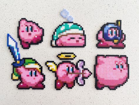 Kirby- Pixel Perler Beads Art, Can be Fridge Magnet, Keychain, Phone Charm, and Badge! --Size-- Kirby 1: 2 1/4 inches tall by 2 inches wide. Kirby 2: 3 inches tall by 2 3/4 inches wide. Kirby 3: 2 inches tall by 2 1/8 inches wide. Kirby 4: 4 inches tall by 3 inches wide. Kirby 5: 3 inches tall by 3 1/2 inches wide. Kirby 6: 2 1/2 inches tall by 2 1/2 inches wide. --Multiple finishes--  Plain: just keep it simple Magnet: a black magnet Keychain: a simple iron ring Phone charm: a black mobile phon Cool Pixel Art Designs, Small Kirby Perler Beads, Lava Lamp Pixel Art, Kirby Fuse Beads, Peeler Bead Magnets, Kirby Pearl Beads, Small Pokemon Pixel Art, Iron Beads Keychain, Kirby Pixel Art Grid