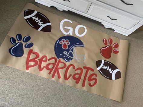 Paper Run Through Banner Football, Peewee Football Signs, Homecoming Arches Football, Red Out Football Signs, Peewee Homecoming Ideas, Spirit Signs For School Football, Painted Cheer Signs For Football, Cheerleading Banners For Football, Sports Cheering Posters