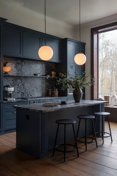 A sophisticated dark blue kitchen with a large island, marble countertops, wood flooring, and circular pendant lights adding a warm glow Moody Kitchen Ideas, Moody Kitchen Design, Modern Dark Kitchen, Moody Kitchens, Dark Countertops Kitchen, Dark Blue Kitchen, Blue Countertops, Island Marble, Dark Kitchens