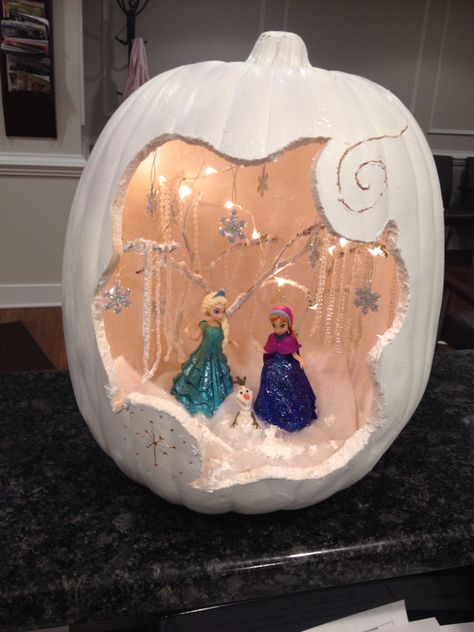 My Frozen pumpkin!  Styrofoam pumpkin from Michael's, some clearance beaded necklaces, figurines from Amazon, poly fill, "snow", twigs from the yard, white spray paint and loads of patience! Elsa Pumpkin Ideas, Ariel Pumpkin Painting, Encanto Pumpkin, Disney Pumpkin Decorating Ideas, Elsa Pumpkin Painting, Frozen Pumpkin Decorating, Disney Pumpkin Decorating, Frozen Pumpkin Painting, Disney Princess Painted Pumpkins