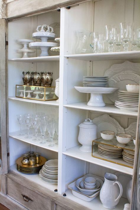 How to style your china cabinet. China Cabinet Essentials A set of white dishes {dinner plates, salad plates, bowls} Set of glassware {stemware & tumbler} Set of Silverware {gold and / or silver} Napkin Rings Chargers 3-5 Serving Platters Large Pitcher Cake Plates Votives & Candle Sticks White Napkins China Cabinet Set Up, How To Store Serving Platters, How To Style Buffet Cabinet, How To Display Glassware, How To Display Dishes In China Cabinet, How To Style China Cabinet, How To Display China In Cabinet, China Cabinet Organization, China Cabinet Display Ideas