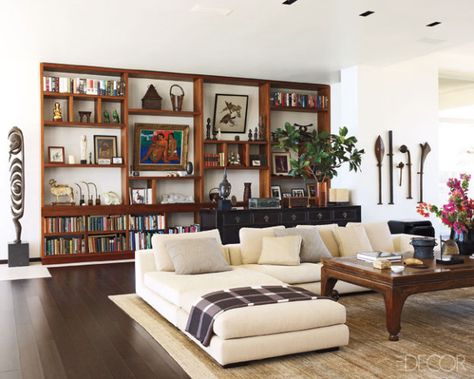 White Walls in the Living Room: A collection of 19th-century Fijian war clubs hangs next to vesi-wood shelving in a library. Indian Home Library, Chinese Living Room, Wall Arrangements, Working Room, Wood Shelving, Indian Living Rooms, Apartments Decorating, Kelly Hoppen, Clean Living