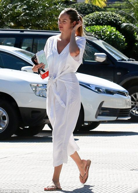 Hands full: The 29-year-old mother-of-two looked summery fresh in a white belted, linen jumpsuit with tan flip-flops as she ran her errands Flip Flops Outfit, Flops Outfit, White Linen Jumpsuit, White Summer Outfits, Free People Jumpsuit, White Flip Flops, Older Women Fashion, Linen Jumpsuit, Candice Swanepoel