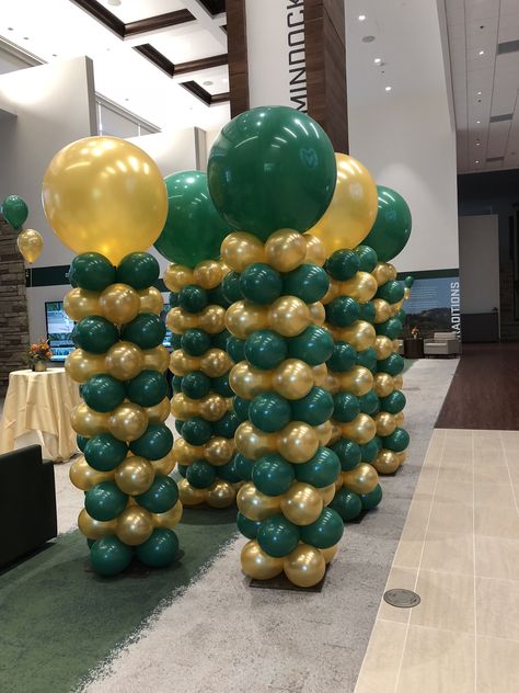 Fast Stack balloon columns with 3 foot Topper- by Balloon Art by Merry Makers Dark Green And Gold Balloon Arch, Green And Gold Balloon Columns, Green And Gold Prom Decorations, Green And Gold Balloons Decoration, Green And Gold Birthday Party Decor, Balloon Column Ideas, Column Ideas, Balloon Tower, Gold Graduation Party