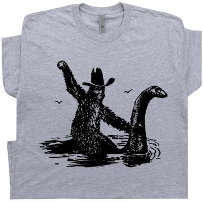 Bigfoot T Shirt | Sasquatch Riding Loch Ness Monster | Cryptozoology T Shirt Sasquatch Shirt, Bigfoot Humor, Loch Ness Monster, Funny Shirts For Men, Loch Ness, Bold Logo, Novelty Shirts, Tee Shirt Homme, Funny T Shirts