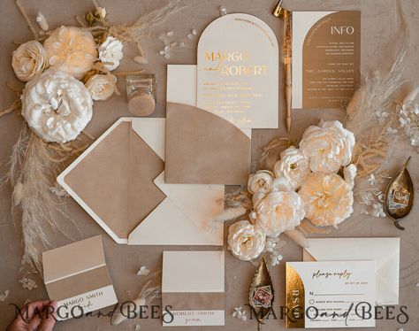 A gold and velvet beige wedding is the epitome of timeless elegance, combining opulence with understated charm. If you're captivated by the allure of this color scheme, here's a comprehensive planning guide to help you achieve the wedding of your dreams. 1. Wedding Invitations Set the tone for your elegant affair with wedding invitations featuring gold accents and velvet beige hues. Choose sophisticated fonts and a design that reflects your wedding's opulent theme. 2. Flowers Choose for neutral Wedding Invitation Cards White And Gold, Neutral Color Wedding Invitations, Chocolate Brown Wedding Theme, Champagne Quince Theme, Mocha Wedding Theme, Unique Wedding Color Schemes, Beige Wedding Theme, Neutral Wedding Theme, Sophisticated Fonts