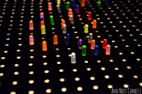 Close up of light bright pegs on a homemade light bright from And Next Comes L Bright Table, Lite Brite, Light Board, Bright Walls, Dollar Store Organizing, Scrapbook Room, Craft Room Storage, Light Bright, Paper Storage