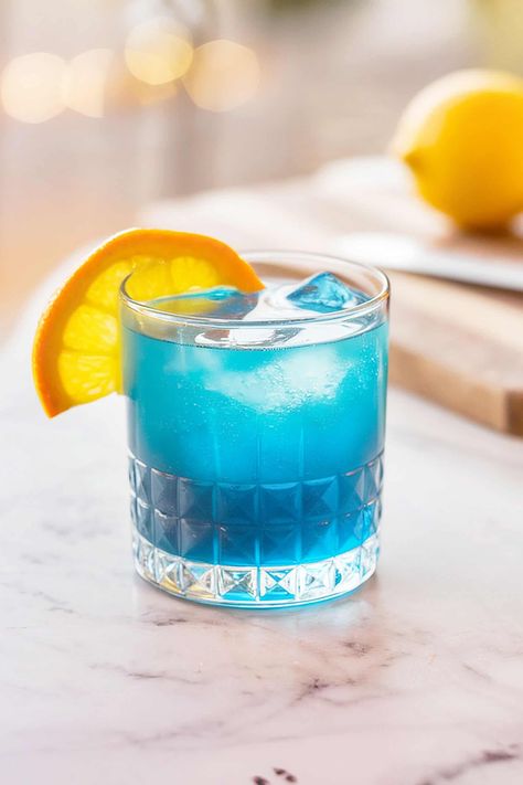 Blue Skies Cocktail Recipe Blue Mocktail Recipe, Blue Curacao Drinks, Hey Bartender, Blue Cocktails, Fruity Desserts, Beachy Vibes, Blue Curacao, Mocktail Recipe, Gin Cocktails