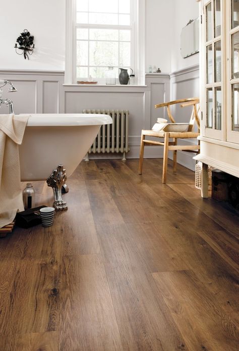 Classic Oak LVP flooring shown in a traditional-styled bathroom with claw foot tub, followed by a close-up angled image. Bathroom Flooring Trends, Flooring Ideas Vinyl, Wooden Bathroom Floor, Design Interior Baie, Best Bathroom Flooring, Oak Timber Flooring, Wood Floor Bathroom, Vinyl Flooring Bathroom, Vinyl Wood Flooring