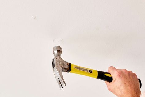 Nails pops are a condition where loose drywall fasteners now stick out. Learn how to fix nail pops in drywall walls and ceilings. Fixing Nail Pops Drywall, How To Fix Ceiling Drywall, Fix Drywall Holes, How To Fix Drywall Hole, Fixing Drywall, How To Fix Big Holes In Drywall, Repair Ceilings, Cracked Nails, Wall Nails