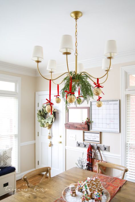 Christmas Balls On Chandelier, Christmas Ornaments Hanging From Chandelier, Light Fixture Decorations For Christmas, Hang Ornaments From Chandelier, Christmas Greenery Chandelier, Christmas Garland On Chandelier, Christmas Decor Dining Room Light, Ribbon On Chandelier Christmas, Bows On Chandelier Christmas