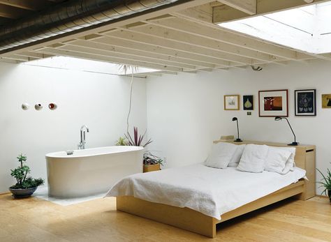 Joint bathroom and bedroom with a Neptune bathtub and wall art Tub In Bedroom, Live Work Studio, Luxurious Bathtubs, Tiny Loft, Artist Bedroom, Live Work Space, Casa Clean, Bedroom With Bath, Attic Rooms