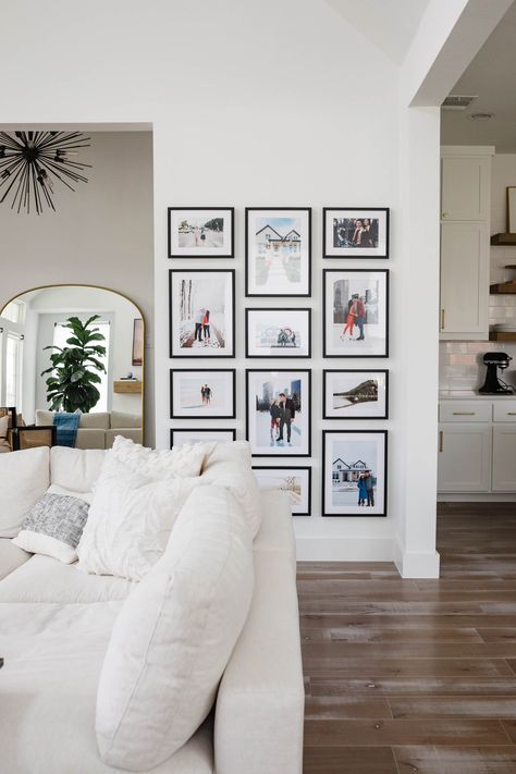 Custom gallery wall in a living room of a transitional home Framebridge Gallery Wall, Gallery Wall Colors, Photowall Ideas, Gallery Wall Layout, Family Photo Wall, Photo Wall Decor, Photo Wall Gallery, Gallery Wall Living Room, Living Room Photos