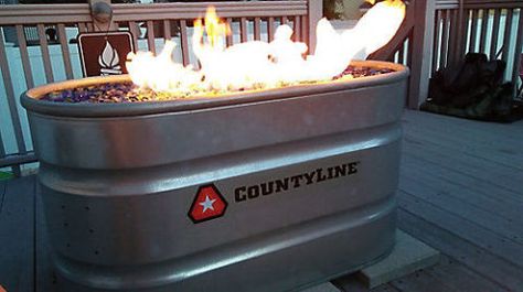 Put your DIY skills to the test with this natural-gas fire pit project.  Get the tutorial at Tractor Supply Co. Propane Tank Fire Pit Diy, Stock Tank Fire Pit, Winery Decorations, Backyard Extension, Backyard Fountain, Diy Stock Tank, Deck Bar, Galvanized Decor, Fire Pit Materials