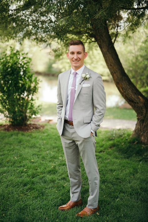 The groom, tailored gray suit, lavender tie Light Gray Suit Lavender Tie, Lavander Suits For Men, Grey Groomsmen Suits With Lavender, Mens Grey Suit Wedding Lavender, Gray Suit With Lavender Tie, Grey Suit Lilac Tie, Grey Suits With Purple Ties, Gray Suit Lavender Tie, Light Grey Suit Purple Tie