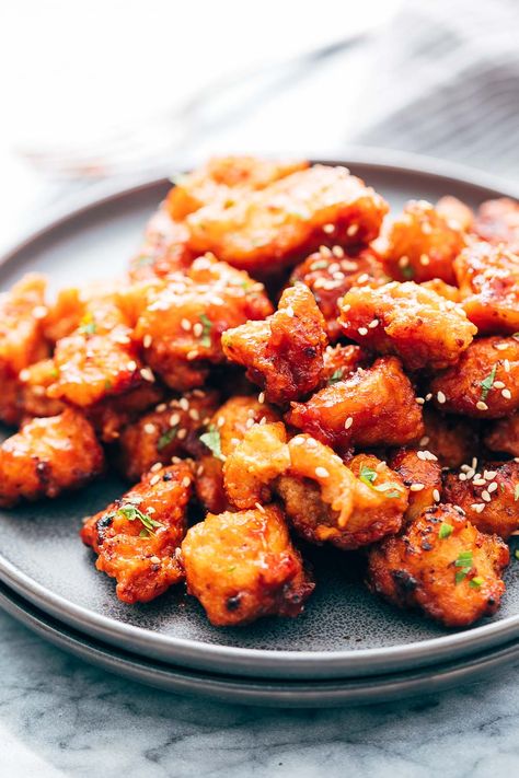 Korean Style Popcorn Chicken. Not complicated! Chicken thighs get tossed with garlic and salt, coated in corn flour and fried. A mix of ketchup (I'd use good quality!), soy sauce, fresh ginger, rice vinegar, and hot sauce get cooked together and then tossed with the fried chicken pieces. Umm, yum! Korean Popcorn Chicken Recipe, Fried Popcorn Chicken, Fried Chicken Sauce, Baked Popcorn Chicken, Chicken Appetizer, Bang Bang Shrimp Recipe, Ginger Rice, Popcorn Chicken Recipe, Appetizer Party