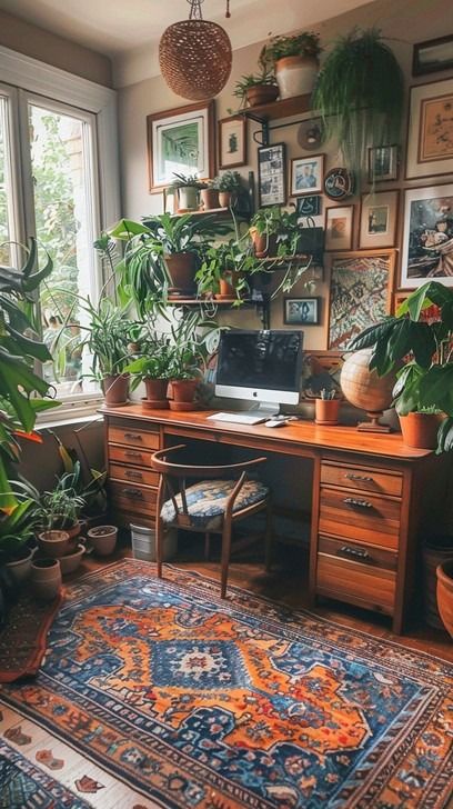 An inviting home office space featuring a wooden desk, vibrant plants, and eclectic wall art. Eclectic Maximalism Desk, Home Office Ideas Eclectic, Boho Writing Desk, Wooden Working Desk, Desk Facing Into Room, Garden Theme Office, Eclectic Maximalism Office, Eclectic Office Decor Workspaces, Small Cozy Office Ideas