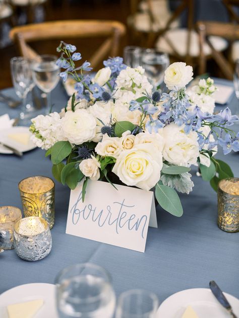 Flower Centerpiece with blue delphinium and silver mercury glass votives Dusty Blue And Navy Centerpieces, Elegant Blue Centerpieces, Dusty Blue Wedding Flowers Centerpieces, Blue Wedding Floral Arrangements, Wedding Flower Arrangements Blue Table Centerpieces, Light Blue And White Centerpieces, Dusty Blue And White Centerpieces, White And Light Blue Centerpiece Wedding, Dusty Blue White And Silver Wedding