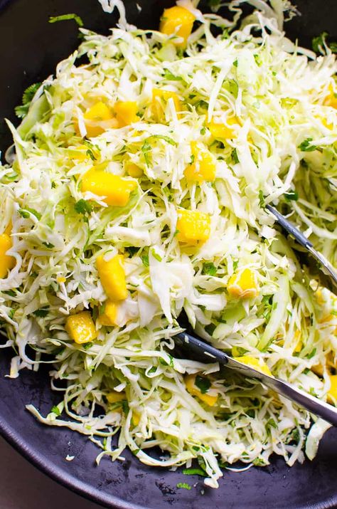 Sweet juicy mangos, crispy crunchy cabbage, and a light vinegar give this Mango Slaw Recipe a sweet and tart combination that elevates everything from burgers, to tacos, to chicken and fish! This mango slaw recipe, truth be told, can be eaten as a salad! Mango Slaw Recipes, Healthy Salmon Burgers, Salmon Burger Recipe, Mango Slaw, Healthy Salmon, Slaw Recipes, Mango Recipes, Mango Salad, Cabbage Slaw