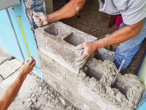 Cinder block is a useful material that can create solid structures indoors and out. While the popular material may be high in durability, it is rather low in aesthetic. Installing tile on a cinder block wall can greatly increase a room's appeal. To tile a block wall, follow a few easy steps. Cinder Block Walls, Wrapping Paper Storage, Brick Laying, Cement Blocks, Concrete Stairs, Concrete Forms, Concrete Table, Poured Concrete, Concrete Projects