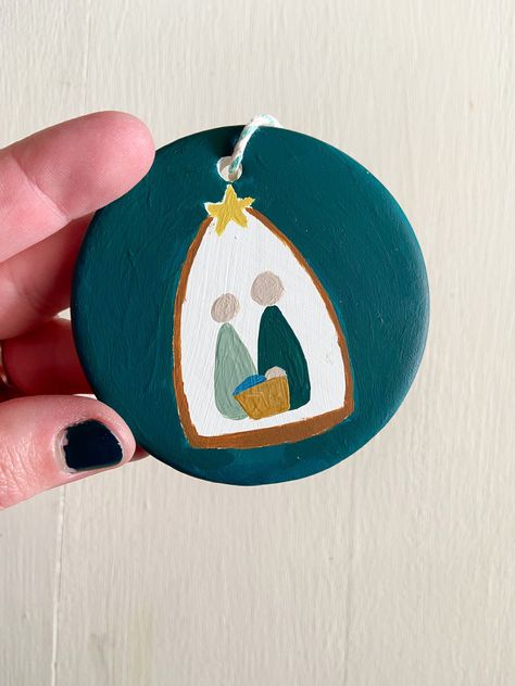 Nativity Ornaments are a sweet addition to decorate your home or tree this holiday season. These hand-painted, one of a kind ornaments make great gifts too. The Nativity Ornaments can be hung throughout the winter season as a reminder of the reason of the season. Give an ornament as a gift or buy multiple to start a collection. acrylic on 3" round clay disc Homemade Nativity Ornaments, Painted Acrylic Ornaments Diy, Wood Slice Nativity Ornament, Acrylic Painted Christmas Ornaments, Wood Round Ornaments Diy Kids, Ornament Ideas Painting, Easy Wood Ornament Painting, Diy Ornaments Paint, Christmas Ornaments Painting Ideas