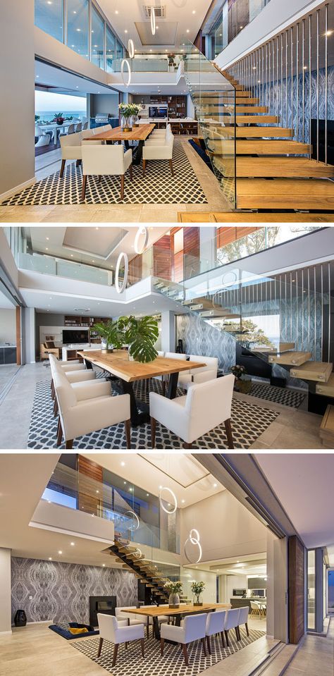 At the bottom of this solid oak and glass staircase is the dining room, with a large wooden table anchored in the space by an artistic rug. Open Stairs In Dining Room, Dining Near Staircase, Dining Area Near Staircase, Staircase In Open Living Area, Dining Room With Staircase, Oak And Glass Staircase, Rug Photography, درج السلم, Open Stairs