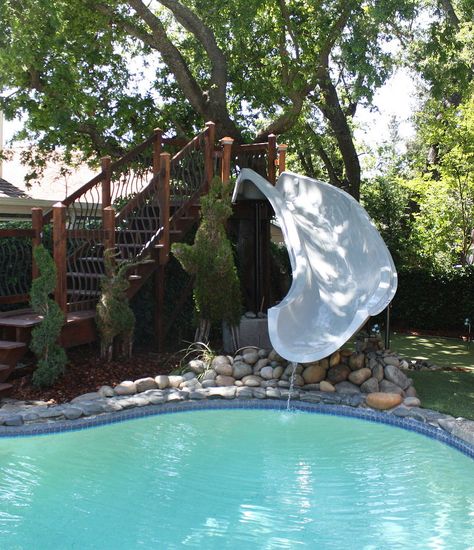 This homeowner stepped out of the box when she added a beautiful 15.5' Dolphin slide to her pool. The gorgeous stairway landing adds a simple elegance to the wa… Pool Slide Diy, Inground Pool Slides, Above Ground Pool Slide, Water Slides Backyard, Backyard Slide, Swimming Pool Slides, Pool Water Slide, Stock Pools, Yard Makeover