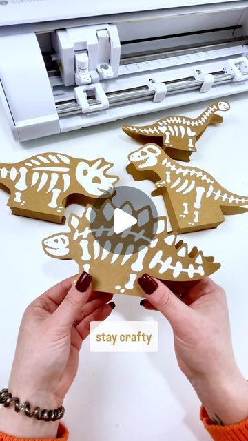 Dinosaur Mama | Craft Tutorials | Free SVG Files on Instagram: "How cute are these little Dino bone treat boxes. You can even use them for Dino party decor 🦖🦕  I used my @silhouette.inc Cameo 5 (and Portrait 3) to cut these guys out and found the designs on the Silhouette Design store.   Tip: if your paper crafts have a lot of pieces to place - save the middle as a guide. This also works great for lettering!   #craftthings #silhouettecameo #silhouettestudio #silhouettecameo5 #papercraft" Dinosaur Party Decorations Diy, Dinosaur Feet Template, Dinosaur Party Diy, Cricut Dinosaur Projects, Paleontology Party, Dino Party Decor, Dinosaur Cut Outs, Dinosaur Party Decor, Dino Party Decorations