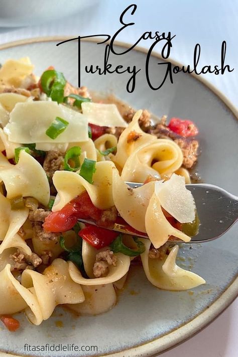 This simple healthy Turkey Goulash Egg Noodles Recipe is make with lean ground turkey and egg noodles. It's light tomato flavor combines with salty feta cheese, green onion, and spices for a flavorful and healthy bite. Get the recipe at fitasafiddlelife.com Ground Turkey With Egg Noodles, Ground Turkey Egg Noodles Recipes, Ground Turkey And Egg Noodles, Ground Turkey And Noodle Recipes, Turkey And Egg Noodles Recipe, Healthy Egg Noodle Recipes, Ground Turkey And Noodles, Turkey And Egg Noodles, Egg Noddle Recipes