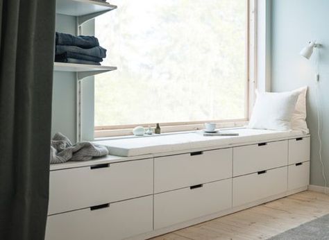 A wall with a window and a row of low bedroom storage made from modern, white chests of drawers Nordli Ikea, Ikea Hack Living Room, Bedroom Window Seat, Ikea Nordli, Bedroom Storage Chest, Soothing Bedroom, Design Ložnic, Peaceful Bedroom, White Chest Of Drawers