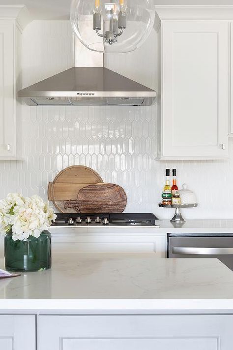 Glossy white picket tiles designed with white cabinets and white quartz countertop in transitional kitchen design. Kitchen Wall Tiles Ideas, Wall Tiles Ideas, Picket Tile, Organize Kitchen, Transitional Kitchen Design, Kitchens Ideas, White Kitchen Backsplash, Tiles Ideas, Kitchen Decorations