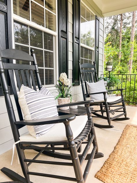 Black Outdoor Rocking Chairs, Front Porch Black Rocking Chairs, Black And White Front Porch Decor, Black Rocking Chairs On Front Porch, White And Black House Exterior, Front Porch With Rocking Chairs, Best Faux Plants, Tiered Plant Stand, Spring Front Porch Decor