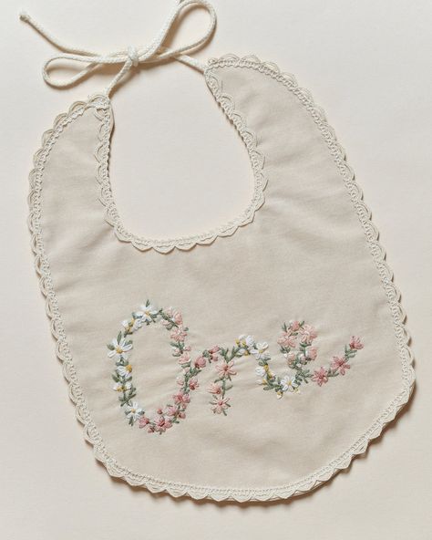 Celebrate your babygirl’s #firstbirthday with a touch of #timeless elegance. Made with meticulous care, this bib features a stunning array of #daisies and vintage-style flowers delicately hand-embroidered to form the word 'One', creating a truly unique and enchanting prop for those precious first birthday photoshoots. Each bib is a labor of love, with us investing countless hours into the intricate handwork that makes every piece a work of art. More than just a prop, this bib is also a #keep... Boho Baby, First Birthday, Labor, Hand Embroidered, First Birthdays, Timeless Elegance, Of Love, Vintage Style, Daisy