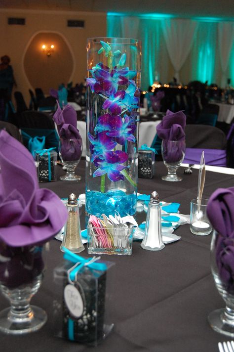 Teal And Purple Wedding Centerpieces, Black And Blue Centerpiece Ideas, Purple And Blue Event Decor, Purple Teal And Red Wedding, Purple Teal And White Wedding, Royal Purple And Turquoise Wedding, Black Purple And Turquoise Wedding, Purple And Teal Centerpieces, Blue Gold And Purple Wedding