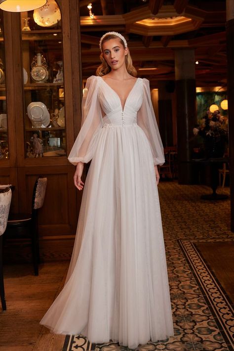 This backless, long sleeved wedding dress will turn you into everything you want to be for your big day. Inspired by the way a feather falls from your hand, the soft tulle on this A-line silhouette allows for a flowy, light weight bridal look. Not to mention her ultra-feminine V neckline and her exquisite lace and button details along her waistline will make jaws drops from one end of the aisle to another. Sleeved Wedding Dress, Calla Blanche, Wedding Dress With Long Sleeves, Spaghetti Strap Wedding Dress, Bridal Gallery, Pretty Wedding Dresses, Wedding Dresses With Flowers, Wedding Dresses With Straps, Dream Wedding Ideas Dresses