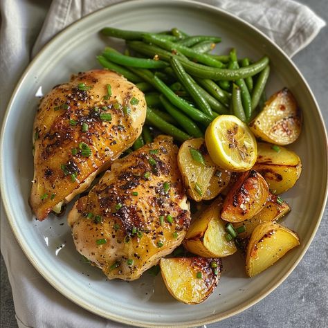 Herb-Roasted Chicken with Lemon and Garlic: A Wholesome Meal Enjoy a wholesome and flavorful dinner with our Herb-Roasted Chicken with Lemon and Garlic! 🍗🍋🌿 Paired with crispy roasted potatoes and fresh green beans, this dish is perfect for a satisfying family meal. Simple to make and absolutely delicious! 🍽️✨ Ingredients 4 bone-in, skin-on chicken breasts 1/4 cup olive oil 4 cloves garlic, minced 1 tablespoon fresh rosemary, chopped 1 tablespoon fresh thyme, chopped 1 lemon, sliced 1 pound ... Rosemary Chicken And Potatoes, Green Beans And Chicken, Chicken Green Beans Potatoes, Crispy Roasted Potatoes, Chicken With Lemon, Chicken Green Beans, Roasted Chicken And Potatoes, Thyme Chicken, Flavorful Dinner