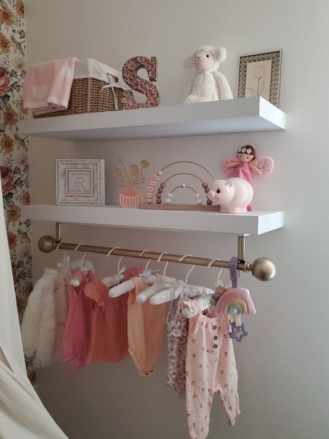 Creating a beautiful and functional nursery is an important part of preparing for a new baby. The shelves in this nursery provide ample space for decorative items and storage for baby essentials such as extras, toys, and blankets. The gold rod with cute clothing adds a touch of charm to the room while also serving a practical purpose. It's fun to regularly update the clothing on the rod. This is one of my favorite parts of the nursery! Twin Baby Rooms, Nursery Shelf Decor, Nursery Shelves, Baby Room Inspiration, Room Baby, Baby Rooms, Beautiful Nursery, Baby E, Girls Nursery