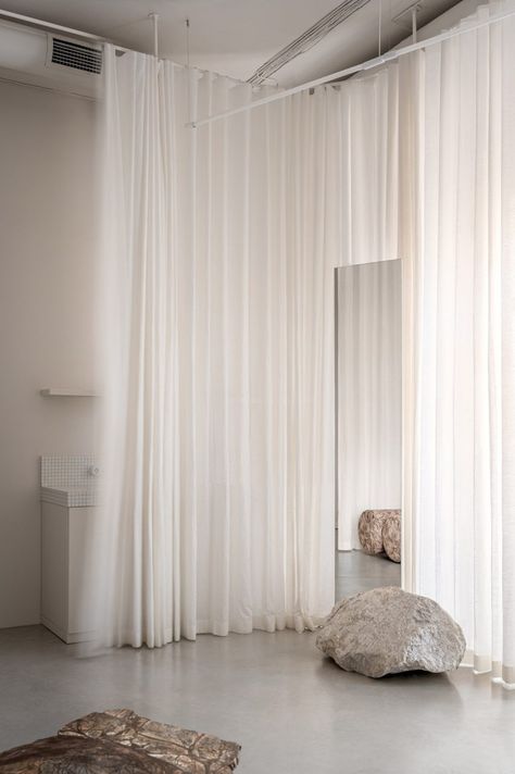 The studio is lined with curtains to soften the space Semi Circle Sofa, Circle Sofa, White Mosaic Tiles, Wooden Lockers, Barre Studio, Styl Hampton, Hair Salon Design, Light Colored Wood, White Mosaic