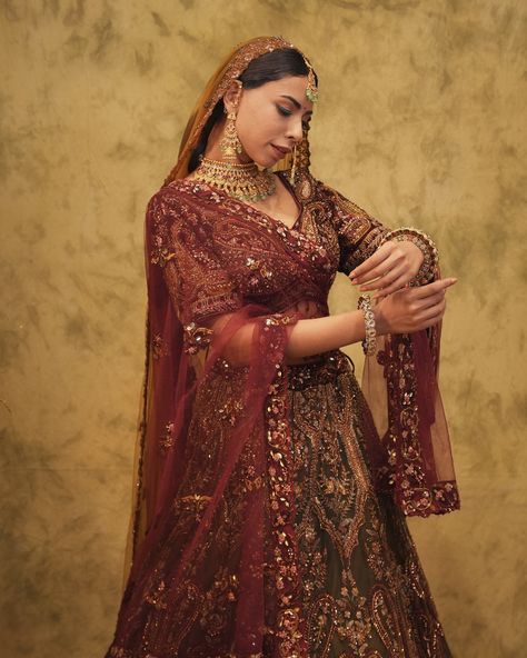 A regal blend of deep maroon and gold, adorned with dapka, sequins, and cutdana. ROOHDAR (روح دار) defines Bridal Luxury! ✨ For further inquiries and shipping details, please reach out to us at the following contacts: 📞India: 721 721 1400 📞US/Canada: +16614078200 📞Australia/ New Zealand:+61483918030 📞UK: +441908103655 #getethnic #roohdar #bridalelegance #bridalwear #customisedclothing #bridal #newcollection #weddingcollection #weddinglehenga #indianbride #bridesofindia #indianwedding #brid... Embroidered Bridal Lehenga, Bridal Lehenga Collection, Deep Maroon, Bridal Elegance, Lehenga Collection, Wedding Lehenga, Color Fabric, Bridal Lehenga, Indian Bride