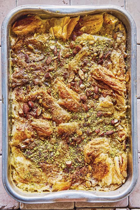 Similar to a bread pudding, this dessert is given a Middle Eastern twist with the addition of toasted nuts and rose water. We like golden raisins (available online and from many stores) for their juicy sweetness in my Om Ali. Darker raisins tend to be less juicy and more puckered, so use the same quantity of chopped dried apricots instead if golden raisins are hard to come by. If you use frozen puff pastry, thaw according to package directions before proceeding. Om Ali Recipe, Om Ali, Egyptian Bread, Cheddar Bread, Ramadan Recipes Iftar, Middle Eastern Sweets, Italian Easter Bread, Apple Cheddar, Moist Yellow Cakes